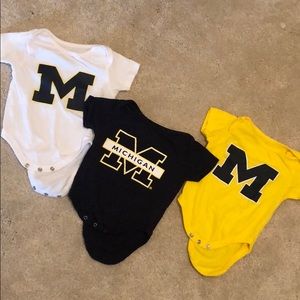 Three 0-3 month University of Michigan onesies.